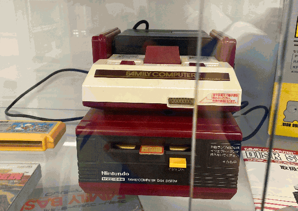 A Famicom with Famicom Disc System underneath